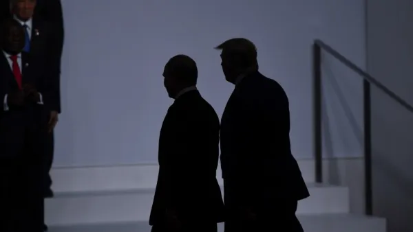 US President Donald Trump (R) walks with Russia's President Vladimir Putin before taking a family photo at the G20 Summit in Osaka on June 28, 2019.  Brendan Smialowski / AFP