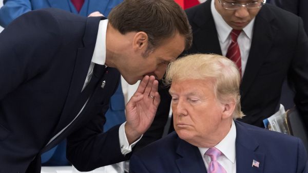France's President Emmanuel Macron (L) speaks to US President Donald Trump as they attend a meeting on the digital economy at the G20 Summit in Osaka on June 28, 2019.  Jacques Witt / POOL / AFP