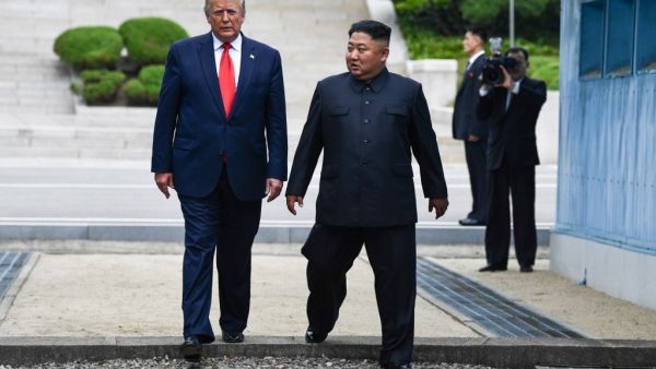 North Korea's leader Kim Jong Un and US President Donald Trump cross south of the Military Demarcation Line that divides North and South Korea, after Trump briefly stepped over to the northern side, in the Joint Security Area (JSA) of Panmunjom in the Demilitarized zone (DMZ) on June 30, 2019.  Brendan Smialowski / AFP