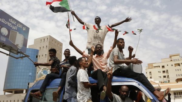 Sudanese people celebrate in the streets of Khartoum after ruling generals and protest leaders announced they have reached an agreement on the disputed issue of a new governing body  (AFP)