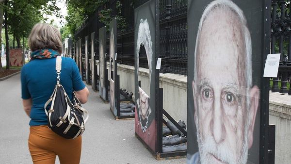 This woman stopped to look at the damage after 80 out of 200 portraits had their faces cut out amid a rising amount of anti-Semitism across Europe. Just days ago German officials warned Jews it was not safe to wear their skullcaps in all parts of the country due to the increasing threat of violence (AFP)
