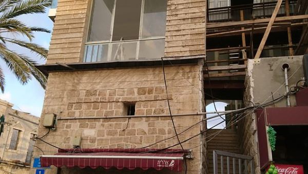 The building had ladders pitched up against crumbling walls, windows with no glass, and a flight of entrance steps that led to a nowhere (dailymail.co.uk)