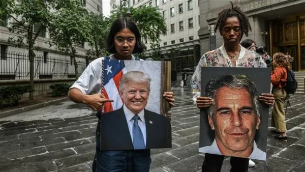 Protesters hold up portraits of Jeffrey Epstein and President Donald Trump in front of the Federal courthouse in New York City, the US, on July 8, 2019 ( AFP)