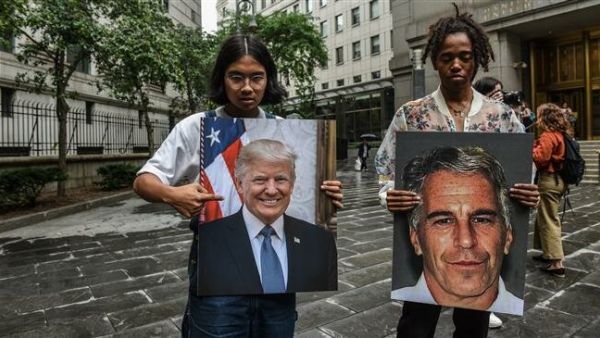 Protesters hold up portraits of Jeffrey Epstein and President Donald Trump in front of the Federal courthouse in New York City, the US, on July 8, 2019 ( AFP)