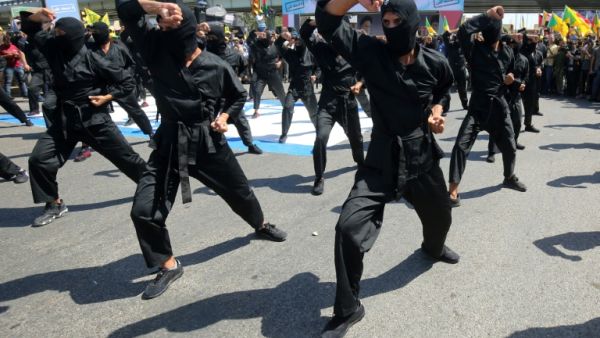 Iraqi Shiite fighters from the Iran-backed Hezbollah brigades take part in a military parade to mark the pro-Palestinian Al-Quds (Jerusalem) Day in Baghdad, May 2020 /AFP