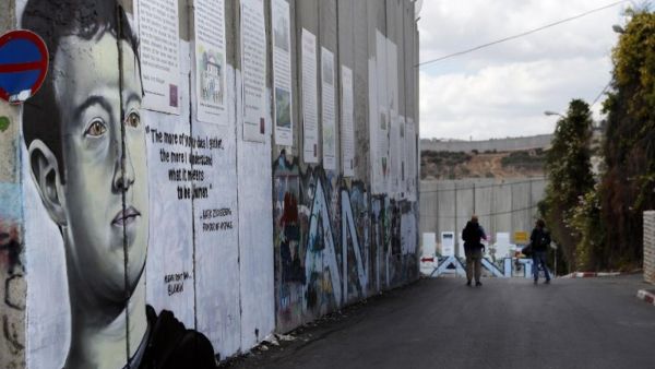 Graffiti depicting Mark Zuckerberg, founder of Facebook, on the Israeli separation barrier /AFP