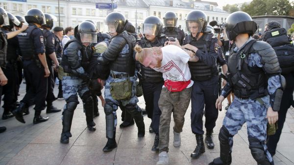 Riot police officers detain protesters during an unauthorised rally demanding independent and opposition candidates be allowed to run for office in local election in September (AFP)