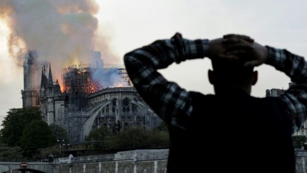 Anxious passers-by watched the landmark cathedral burn (AFP/Geoffroy VAN DER HASSELT) Anxious passers-by watched the landmark cathedral burn (AFP/Geoffroy VAN DER HASSELT)