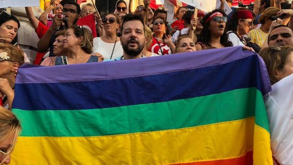 Shams President Mounir Baatour holds a rainbow banner during an August 2018 demonstration in Tunisia. (Facebook/Mounir Baatour)