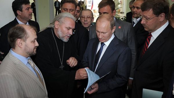 Father Nikolai meets President Vladimir Putin at the 2012 opening of the Russian Centre for Science and Culture in Bethlehem, Palestine.