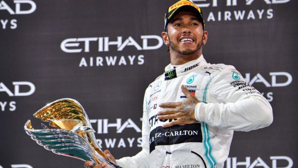 Mercedes' British driver Lewis Hamilton celebrates his win at the Yas Marina Circuit in Abu Dhabi, after the final race of the Formula One Grand Prix season, on December 1, 2019
