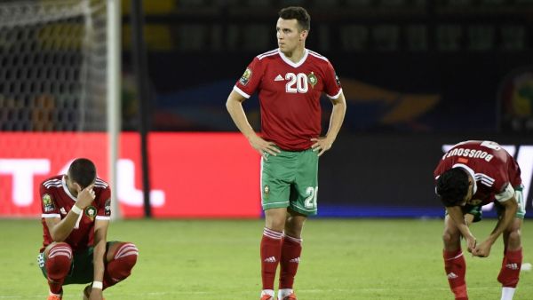Moroccan players react after losing the penalty shoot-out