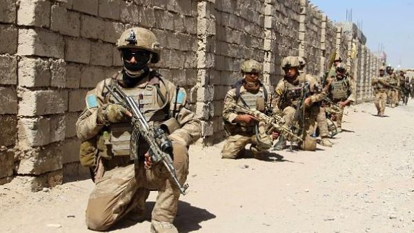 Afghan National Army commandos take position during a military operation in Helmand province. (NOOR MOHAMMAD/AFP/GETTY IMAGES)