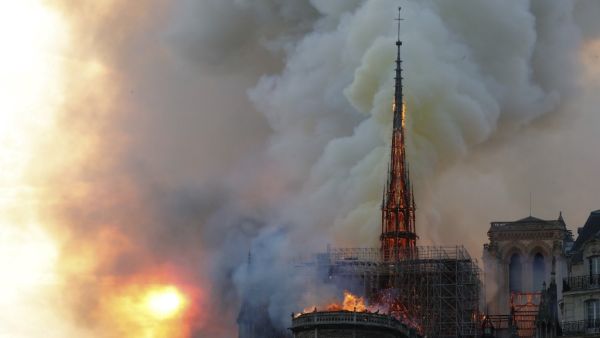 Smoke billow and flames burn from the roof of the landmark Notre-Dame Cathedral in central Paris on April 15, 2019. FRANCOIS GUILLOT / AFP
