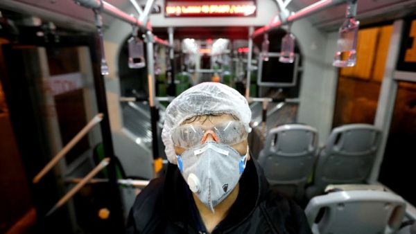A Tehran Municipality worker cleans a bus to avoid the spread of the COVID-19 illness on February 26, 2020. Iran said Tuesday its coronavirus outbreak, the deadliest outside China, had claimed 15 lives and infected nearly 100 others -- including the country's deputy health minister. AFP