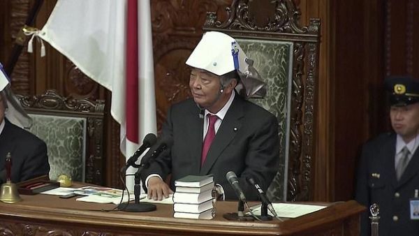 Tadamori Oshima, the lower house speaker, pictured yesterday donning his own white helmet, told the representatives that he always wanted them to be alert. 'You never know when disaster will strike,' he said  (Daily Mail)