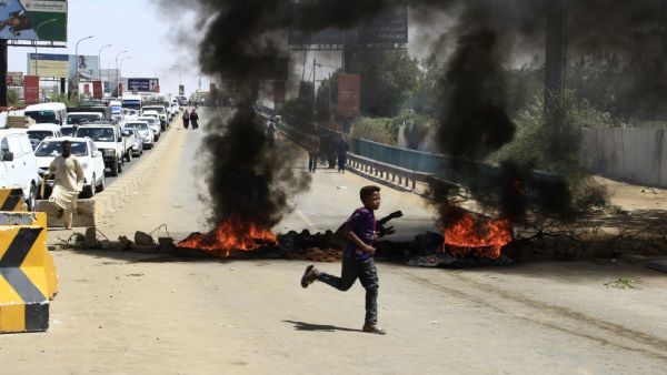 Tires are pictured ablaze during a demonstration in the capital Khartoum on May 13, 2019. (EBRAHIM HAMID / AFP)
