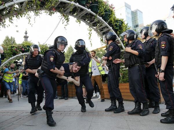 Riot police officers detain a protester during an unauthorised rally demanding independent and opposition candidates be allowed to run for office in local election in September, at Moscow's Trubnaya Square on July 27, 2019.  Maxim ZMEYEV / AFP
