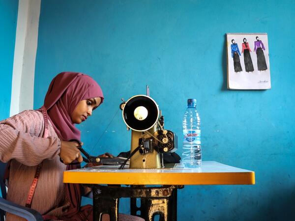 Hawa Adan Hassan, 23 year-old, university student, uses a sewing machine at her home in Mogadishu, Somalia. Abdi HAJJI HUSSEIN / AFP