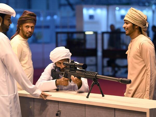 A visitor inspects a sniper rifle during the Abu Dhabi International Hunting and Equestrian exhibition (ADIHEX) in the UAE capital Abu Dhabi on August 31, 2019.  KARIM SAHIB / AFP