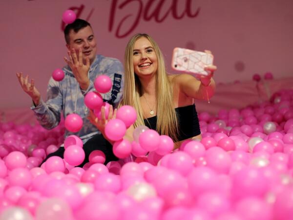 Visitors take and pose for "selfie" photographs at The Selfie Factory in Westfield London shopping centre in west London on September 11, 2019. ISABEL INFANTES / AFP