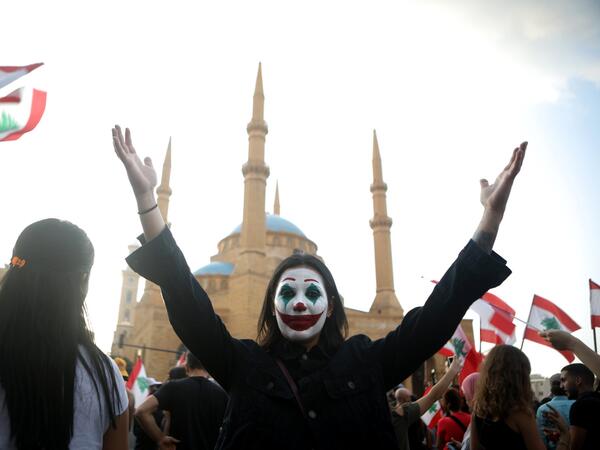 A Lebanese demonstrator, her face painted as DC comic book and film character "The Joker", takes part in a protest in the capital Beirut's downtown district's Martyr's Square (Twitter)