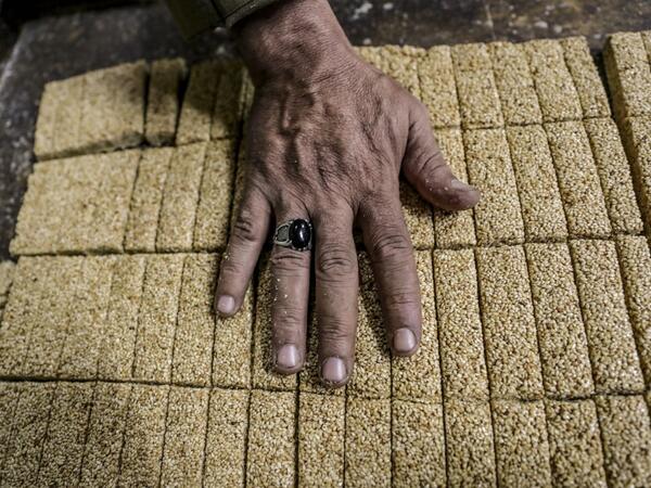 An Egyptian confectioner shows bars of sweets with sesame at a candy factory in the capital Cairo on November 2, 2019, ahead of celebrations of the Muslim Prophet Mohammed's birthday, known as "Al Mawlid Al Nabawi". Prophet Mohamed was born in Saudi Arabia's arid mountainous city of Mecca, the holiest in Islam, some 1490 years ago. Sunni Muslims in many parts of the world celebrate his birthday on the 12th day of the third month of the Islamic calendar, which will fall this year on November 9th.  Mohamed el