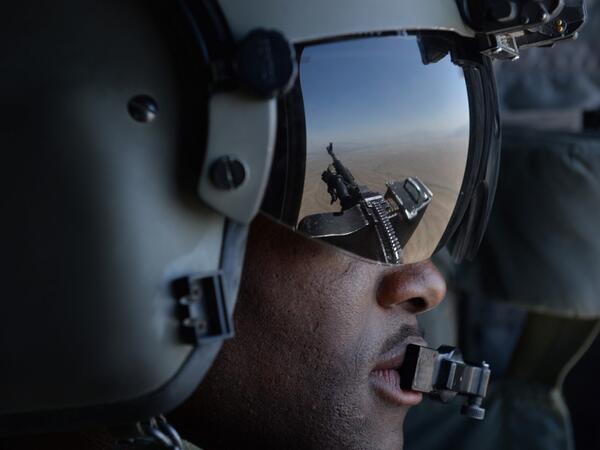 In this file photo taken on August 11, 2014, a US soldier, part of the NATO-led International Security Assistance Force (ISAF), looks out onboard a Chinook helicopter over the Gardez district of Paktia province. American forces have started pulling out of two bases in Afghanistan, a US official said on March 10, 2020 the day peace talks between Kabul and the Taliban were due to start despite widespread violence and a political crisis. The United States is keen to end its longest-ever conflict, and under the