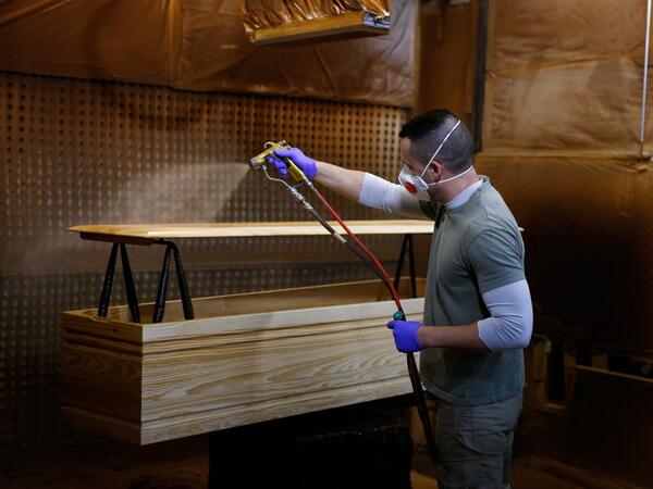 An employee makes a coffin at the Eurocoffin coffins factory in Barcelona on April 3, 2020. More than 900 people died in Spain over the past 24 hours for the second day running, government figures showed, although the rate of new infections and deaths continued to slow. Spain has the world's second-highest death toll after Italy with the virus so far claiming 10,935 lives from 117,710 confirmed cases.  PAU BARRENA / AFP