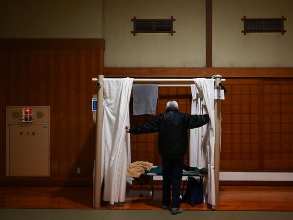 Katsuya Asao, 54, prepares to rest at a shelter provided by Kanagawa prefecture for the people who can’t afford to rent an apartment and used to stay at designated internet cafes, which are closed due to the COVID-19 coronavirus outbreak state of emergency, at a Judo sport hall in Yokohama, Kanagawa prefecture on April 13, 2020. CHARLY TRIBALLEAU / AFP