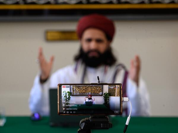 Imam Hassanat Ahmed delivers his Friday broadcast entitled 'Preparing for a Unique Ramadan' via multiple social media platforms from the otherwise empty Noor Ul Islam Mosque on the day before Ramadan commences in the UK, in Bury, Greater Manchester on April 24, 2020. The mosque, like all religious venues, has been closed to worshipers during the national lockdown due to the novel coronavirus COVID-19 pandemic. OLI SCARFF / AFP