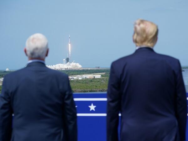 US President Donald Trump watches the SpaceX Falcon 9 rocket carrying the SpaceX Crew Dragon capsule, with astronauts Bob Behnken and Doug Hurley, lifts off from Kennedy Space Center in Florida on May 30, 2020. Trump travels to Kennedy Space Center in Florida to watch the launch of the manned SpaceX Demo-2 mission to the International Space Station. MANDEL NGAN / AFP
