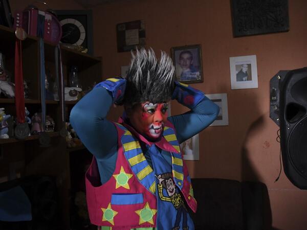 Mostacita.com clown prepares before taking to the streets to beg for money to survive the crisis caused by the new coronavirus in Villa Nueva, 20 km south Guatemala City, on June 10, 2020, as clowns have been unable to work due to restrictions to prevent the spread of the COVID-19.  Johan ORDONEZ / AFP