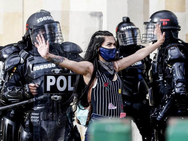 Riot police detain a demonstrator during protests against police brutality in Bogota on September 21, 2020. Large groups of protesters are mobilizing in Colombia against police violence and in rejection of the government, after the bloody protests that unleashed the recent murder of a man at the hands of two uniformed men. LEONARDO MUNOZ / AFP