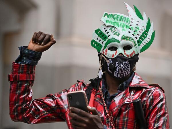 Protestors attend a demonstration outside the Nigerian High Commission against police brutality in Lagos in London on October 21, 2020. UN Secretary General Antonio Guterres called Wednesday for an end to what he called "brutality" by police in Nigeria, which has been rocked by two weeks of protests. Guterres said gunmen that opened fire on peaceful protesters Tuesday evening in Lagos caused "multiple deaths" and many injuries. DANIEL LEAL-OLIVAS / AFP
