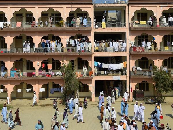 In this picture taken on October 19, 2020 Islamic seminary students gather in the premises of the hostel at the Darul Uloom Haqqania seminary in Akora Khattak which has churned out a who's who of Taliban top brass -- including many now on the hardline group's negotiating team holding talks with the Kabul government to end a 20-year war. Abdul MAJEED / AFP