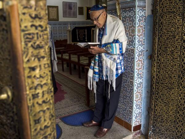  In this file photo taken on October 13, 2017, Moroccan Jews and Israeli Jewish tourists participate in a religious ceremony to observe the holiday of Sukkot (the Feast of the Tabernacles) at a synagogue in the "Mellah" Jewish quarter of the Medina in Marrakesh. Jewish history and culture in Morocco will now be part of the school curriculum -- a "first" in the region and in the North African country, where Islam is the state religion. Morocco's Jewish community has been present since antiquity and grew over