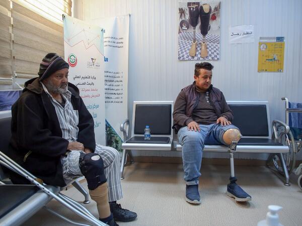 Patients wait for a consultation at the National Center for Artificial Limbs, in Libya's port city of Misrata, on December 17, 2020. With Libya's health sector left in tatters by its multiple conflicts since the 2011 revolution, war-wounded Libyans are often sent abroad for treatment, at the expense of the state. However, A national centre for prostheses, being established in Misrata, already has a patient waiting list of more than 3,000 amputees, and its director hopes to be able in 5 years "to provide pro