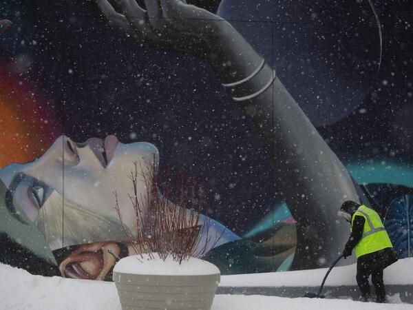 A worker cleans the stairs outside The Vessel in Hudson Yards during a winter storm on February 1, 2021 in New York City. A powerful winter storm is set to dump feet of snow along a stretch of the US east coast including New York City on February 1, 2021, after blanketing the nation's capital. The National Weather Service issued storm warnings from Virginia to Maine -- a swathe home to tens of millions of people -- and forecast snowfall of 18 to 24 inches (45-60 centimeters) in southern New York, northeaste