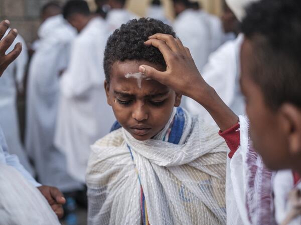 An Ethiopian Orthodox child gets a cross drawn in his forehead with ashes during the religious celebration of Saint Michael in the city of Bahir Dar, Ethiopia