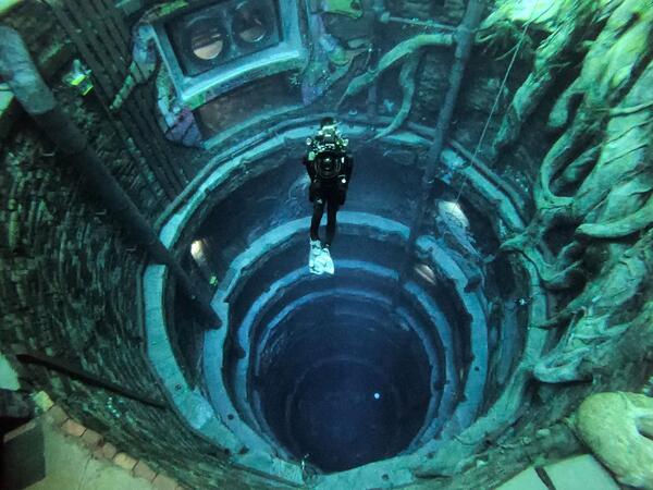 A diver experiences Deep Dive Dubai, the deepest swimming pool in the world reaching 60m, in the United Arab Emirates, on July 10, 2021. The city of superlatives, with the world's tallest tower among its many records, Dubai now has the deepest swimming pool on the planet complete with a "sunken city" for divers to explore. GIUSEPPE CACACE / AFP
