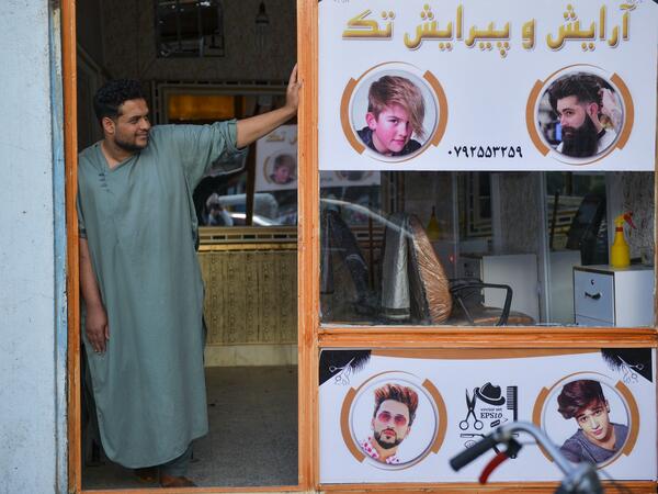 In this picture taken on September 19, 2021, a barber waits for customers at his shop in Herat. 