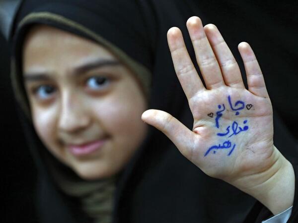 An Iranian girl shows her hand with a slogan reading in Farsi: "Ready to sacrifice my self for the leader" at the tomb of Iran's late founder of the Islamic Republic, Ayatollah Ruhollah Khomeini, 
STR / afp