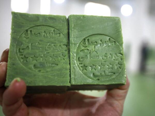 A Syrian worker displays soap bars in a factory on the outskirts of Aleppo 
LOUAI BESHARA / AFP