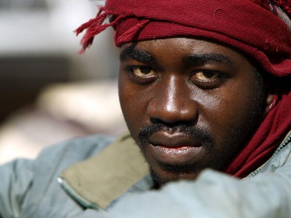 A sub-Saharan migrant sits at the Qanfouda detention center, in the southern outskirts of Benghazi, before being repatriated on Dec. 2, 2017. 
(Abdullah DOMA / AFP)