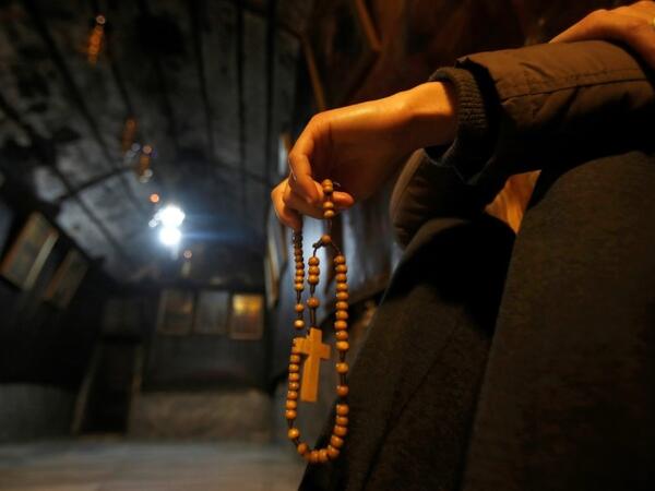 A Christian worshipper prays inside the Grotto, believed to be the exact spot where Jesus was born, at the Church of the Nativity in the biblical West Bank city of Bethlehem, on December 22, 2018, three days ahead of the Christmas celebration. Musa Al Shaer/ AFP