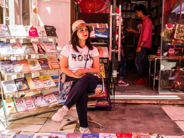 On Baghdad's famous al-Mutanabbi Street, bookstore owner Bara'a al-Bayati welcomes her customers with a smile (Twitter)