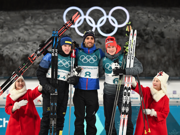 (L-R) Sweden's second place winner Sebastian Samuelsson, France's winner Martin Fourcade and Germany's third place Benedikt Doll pose on the podium during the victory ceremony after the men's 12,5km pursuit biathlon event during the Pyeongchang 2018 Winter Olympic Games in Pyeongchang on February 12, 2018. 
(FRANCK FIFE / AFP)