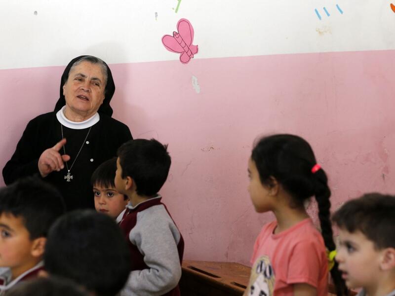 Angel Allam, a nun and teacher instructs her students in the Aramaic language, the biblical language of Jesus, at a school in the mountain village of Maalula, in Syria's Damascus region on May 13, 2019. LOUAI BESHARA / AFP