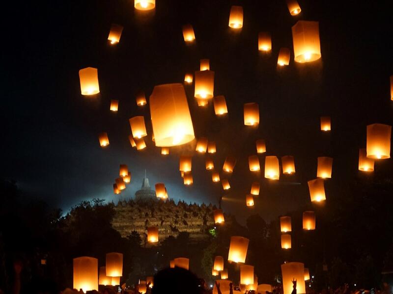 Buddhist devotees release lanterns into the air as a symbol of peace to honour Buddha's birthday, also known as Vesak celebrations, at Borobudur temple in Magelang, Central Java, early on May 19 2019. OKA HAMIED / AFP